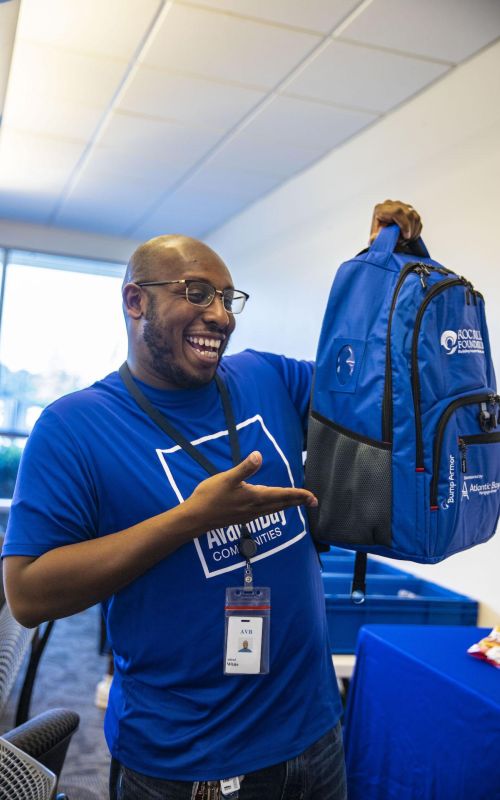 Smiling Volunteer Holding Roc Solid Ready Bag