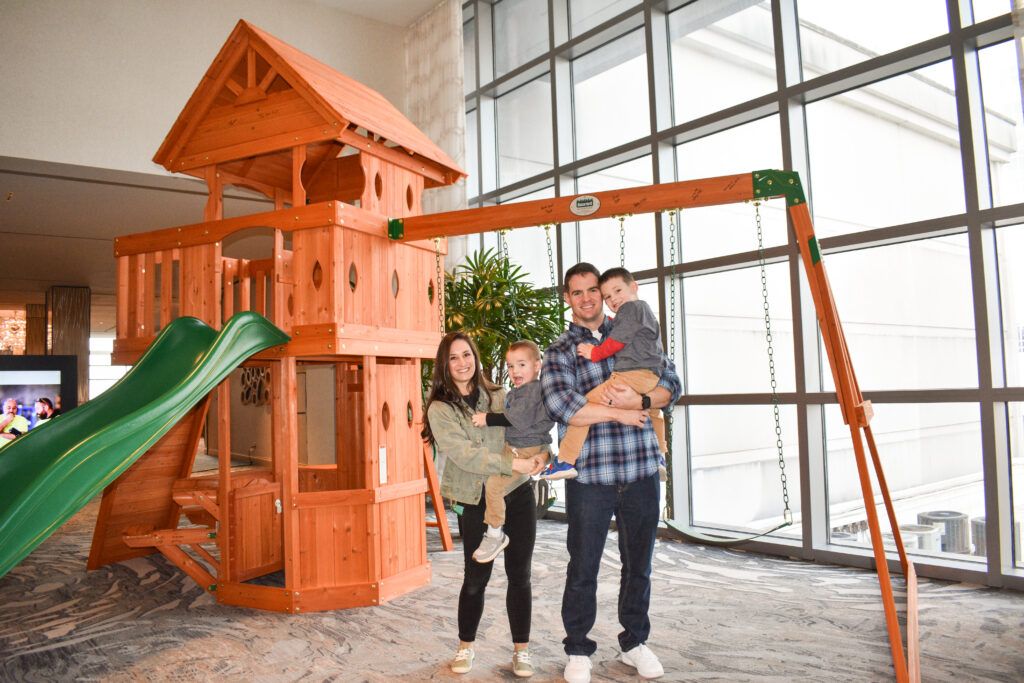 Colt and his family in front of his new playset!