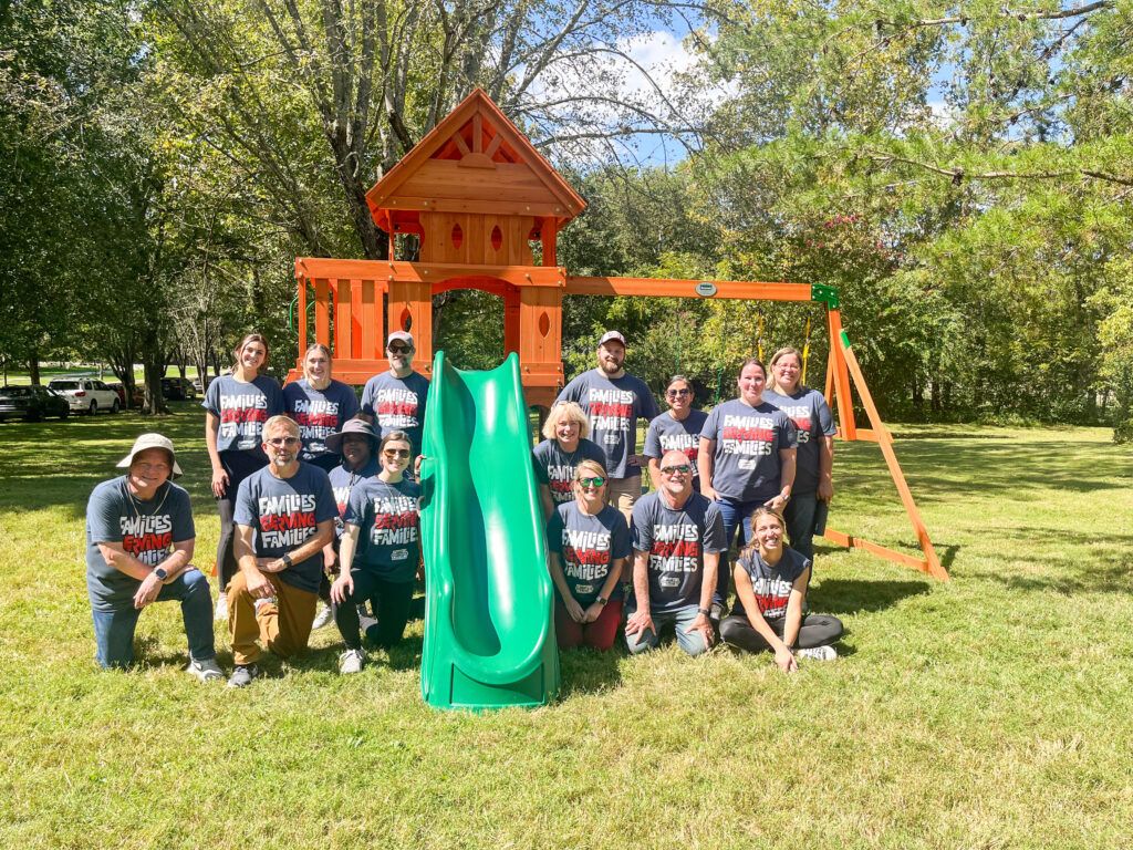 Hunt Brothers Pizza volunteers with the playset they built for pediatric cancer patient.