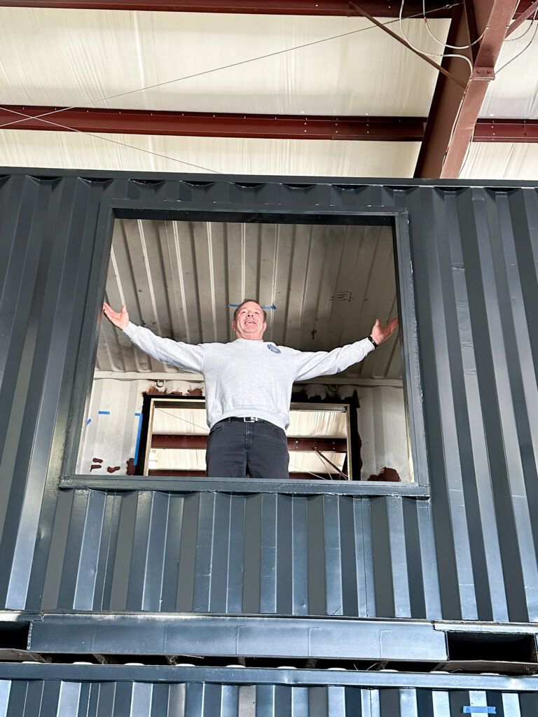  James Templeton, President of All First and Roc Solid volunteer, takes in the view from the top level of the new offices. 