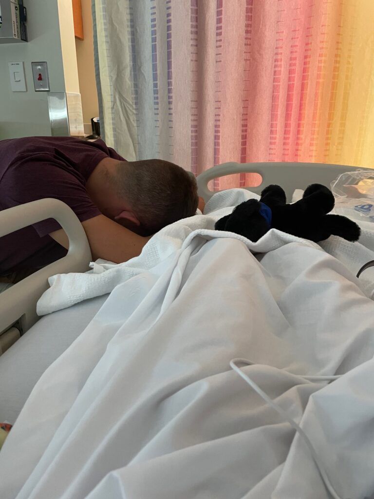John Gonce praying at the foot of Joshua's hosptial bed