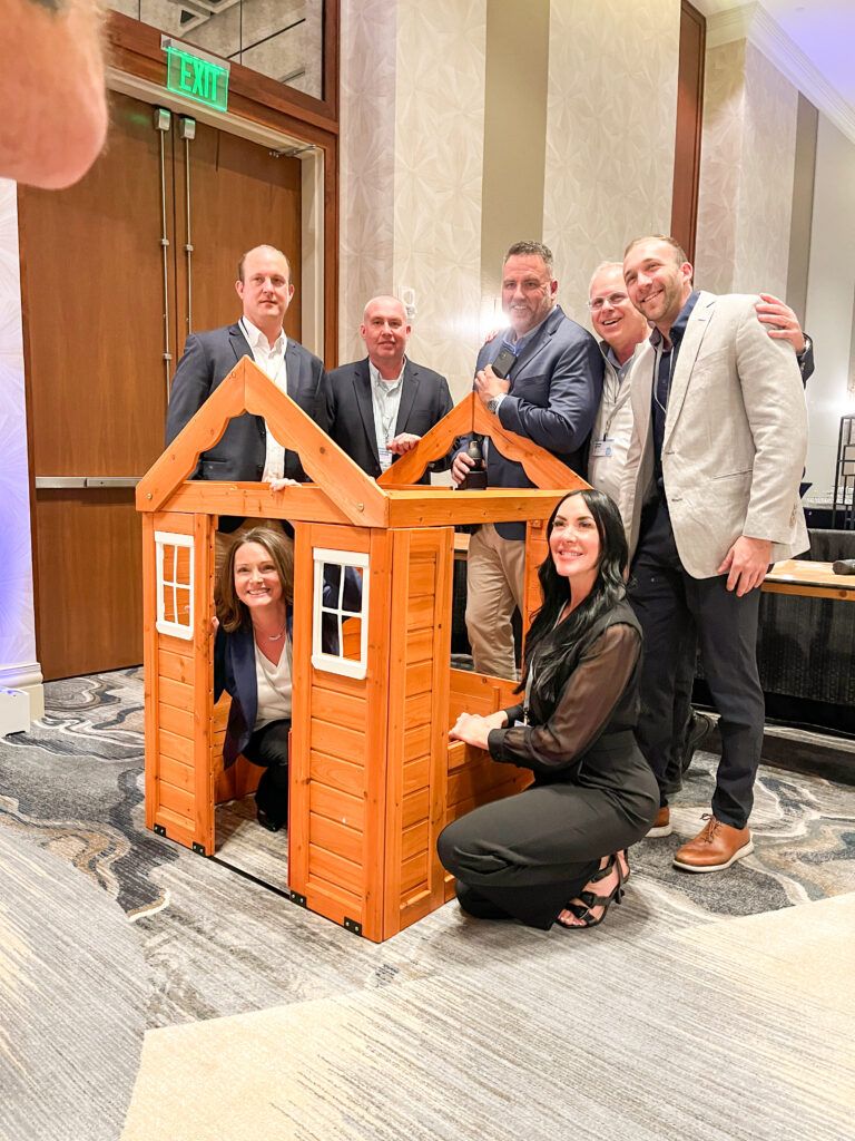 Lansing team with the playhouse the built for a pediatric cancer patient.