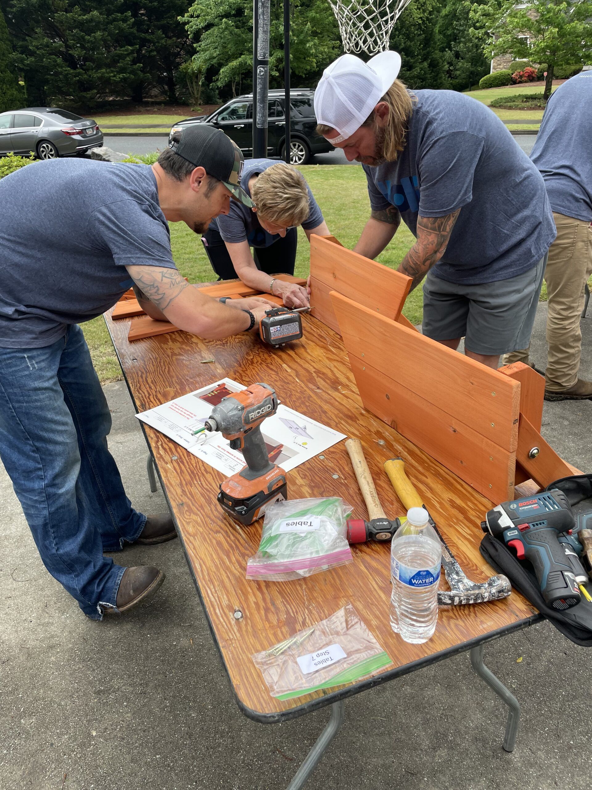 Ark Restoration employees building a playset for Mia.