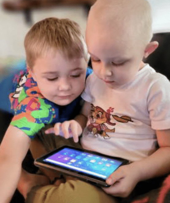 Sailor and her brother playing on their new tablet from their Ready Bag.