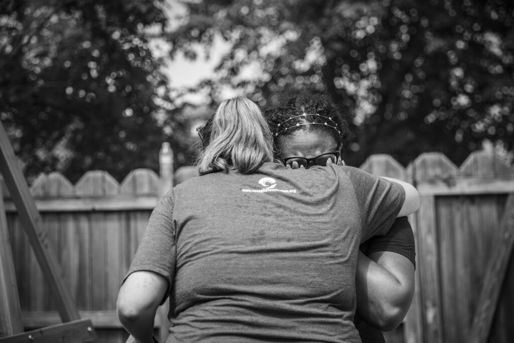 Erin and Layota share a sweet moment at Mason's playset build. 