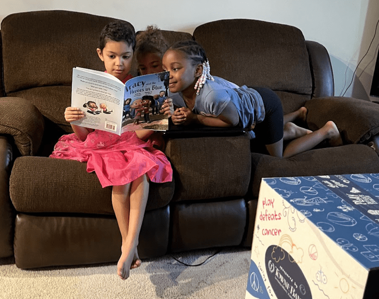 Siblings reading "Tracy and the Heroes in Blue" book together!