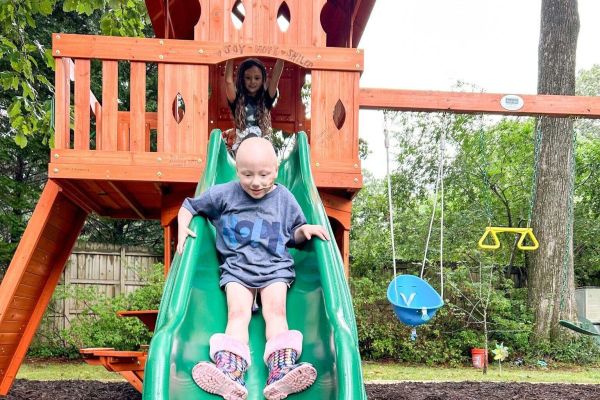 Lilah sliding down her playset!